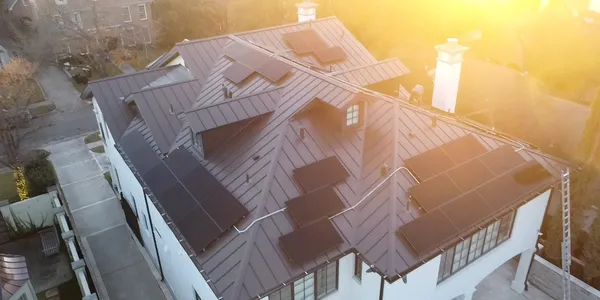 Premium metal roof with solar array in the evening sun